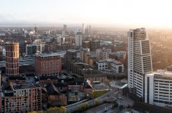 LEEDS, UK - APRIL 20, 2023. An aerial panoramic view of a Leeds cityscape skyline with The Bridgewater Place skyscraper bathed in early morning sunlight at sunrise