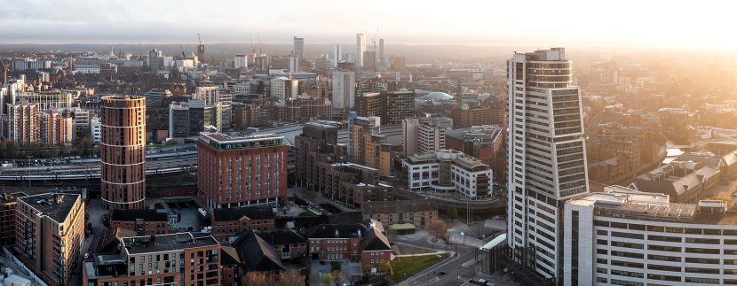LEEDS, UK - APRIL 20, 2023. An aerial panoramic view of a Leeds cityscape skyline with The Bridgewater Place skyscraper bathed in early morning sunlight at sunrise