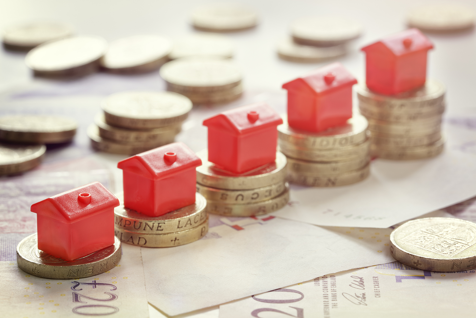 estate agents hackney london - Minature houses resting on pound coin stacks